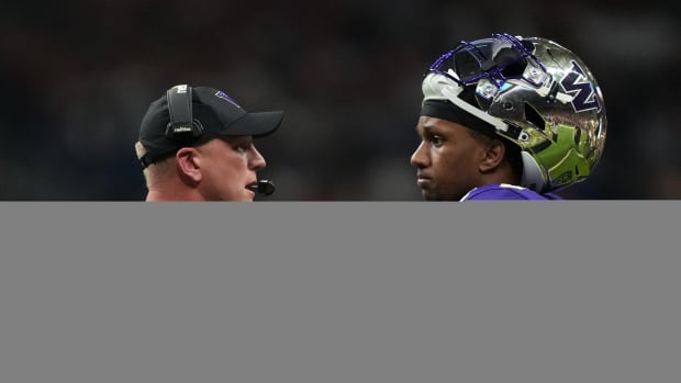 Washington Huskies head coach Kalen DeBoer (left) talks with quarterback Michael Penix Jr. (9) in the first half of the 2022 Alamo Bowl against the Texas Longhorns at Alamodome.